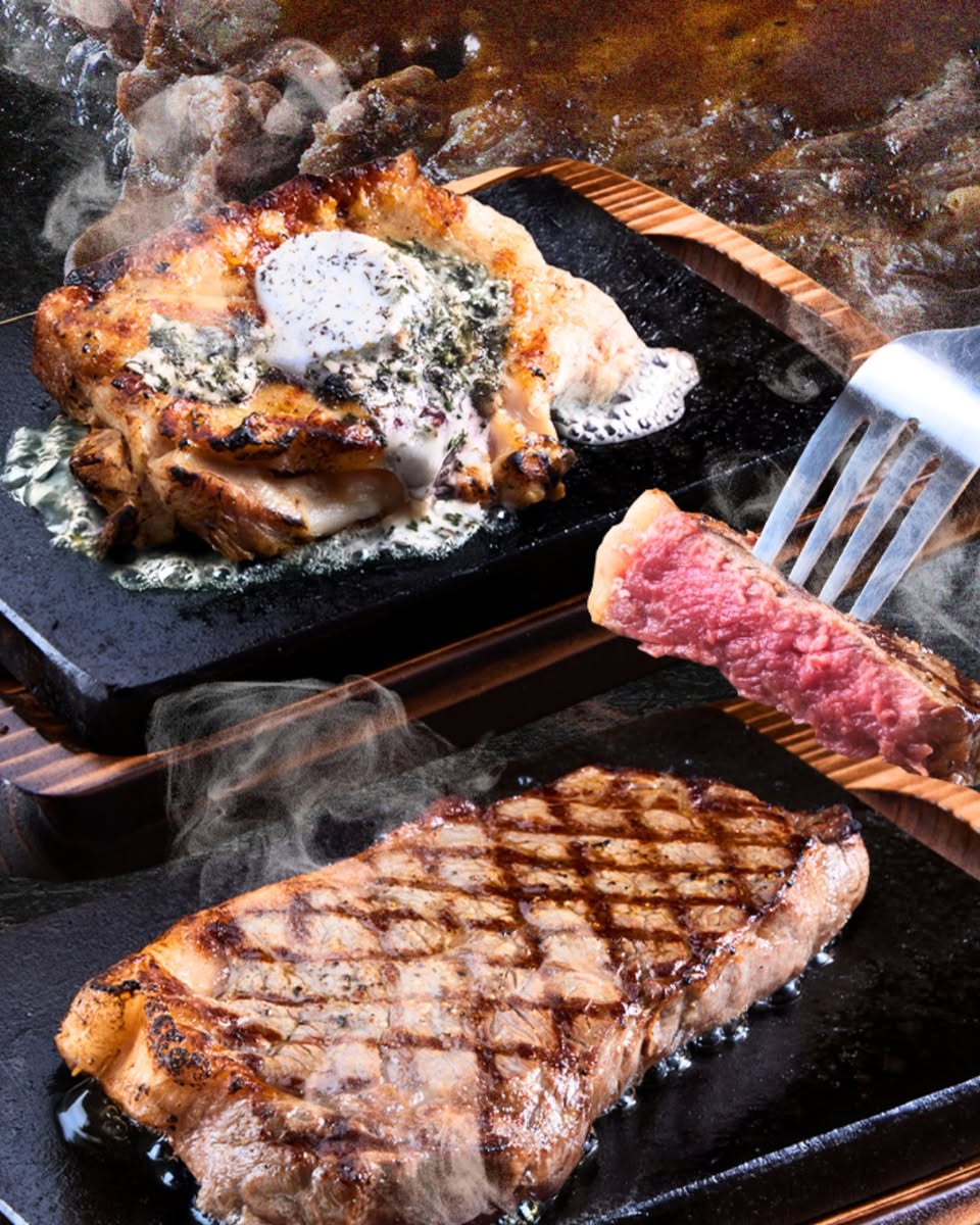 A beautifully cooked steak resting on a hot lava stone.