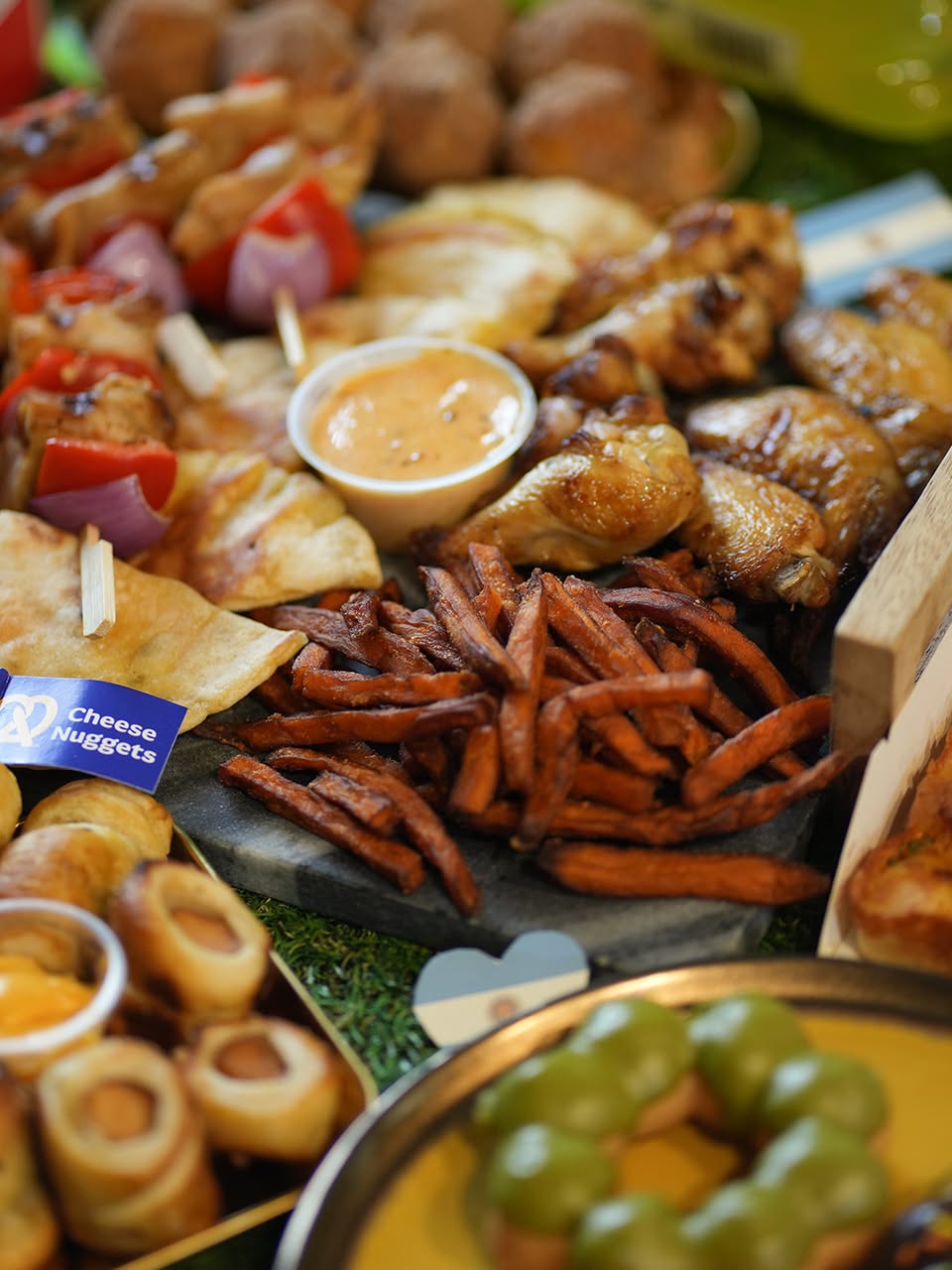 Food platter with chicken wings, fries and cheese nuggets