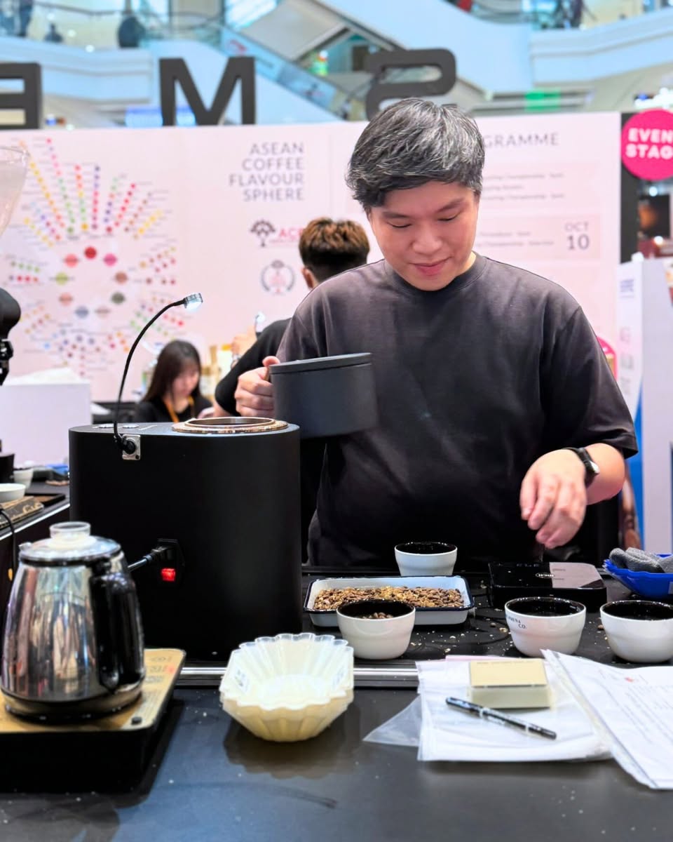 People enjoying coffee at a bustling cafe during an event
