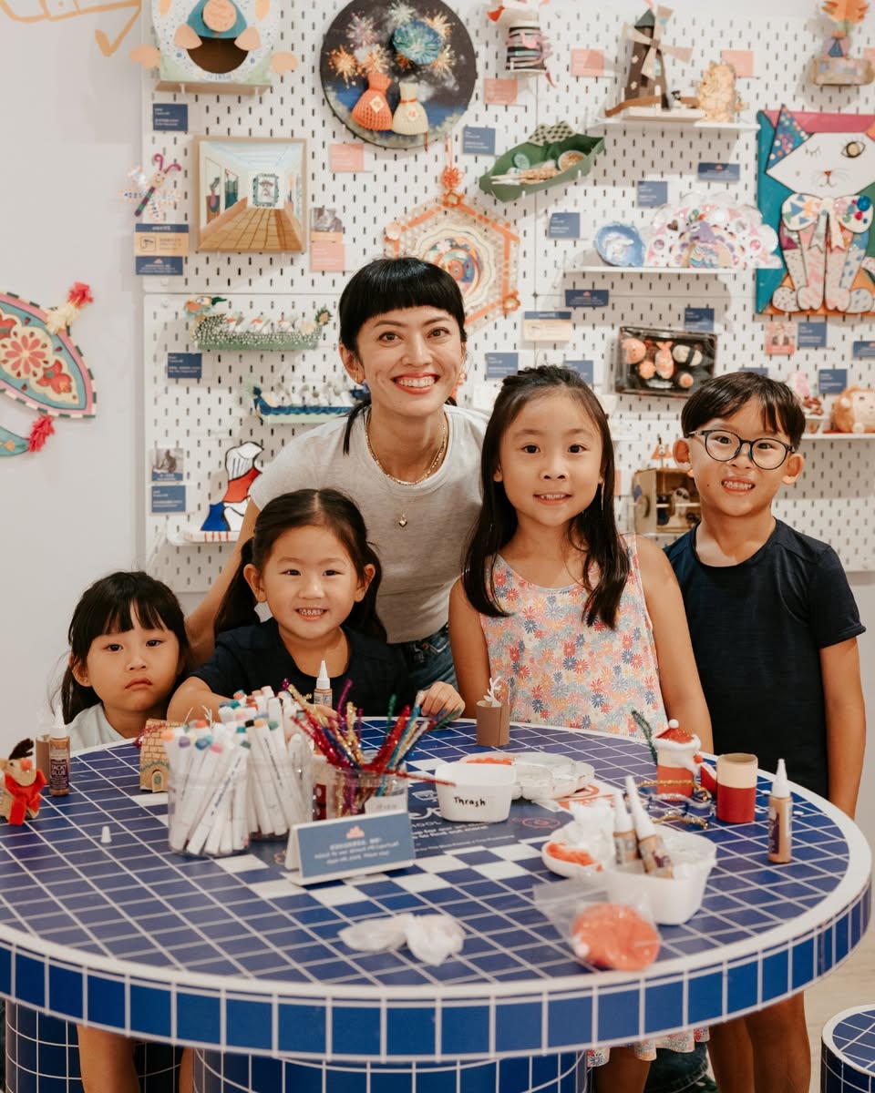 Attendees engaging in a hands-on craft session at the Pei-Per Arts School event