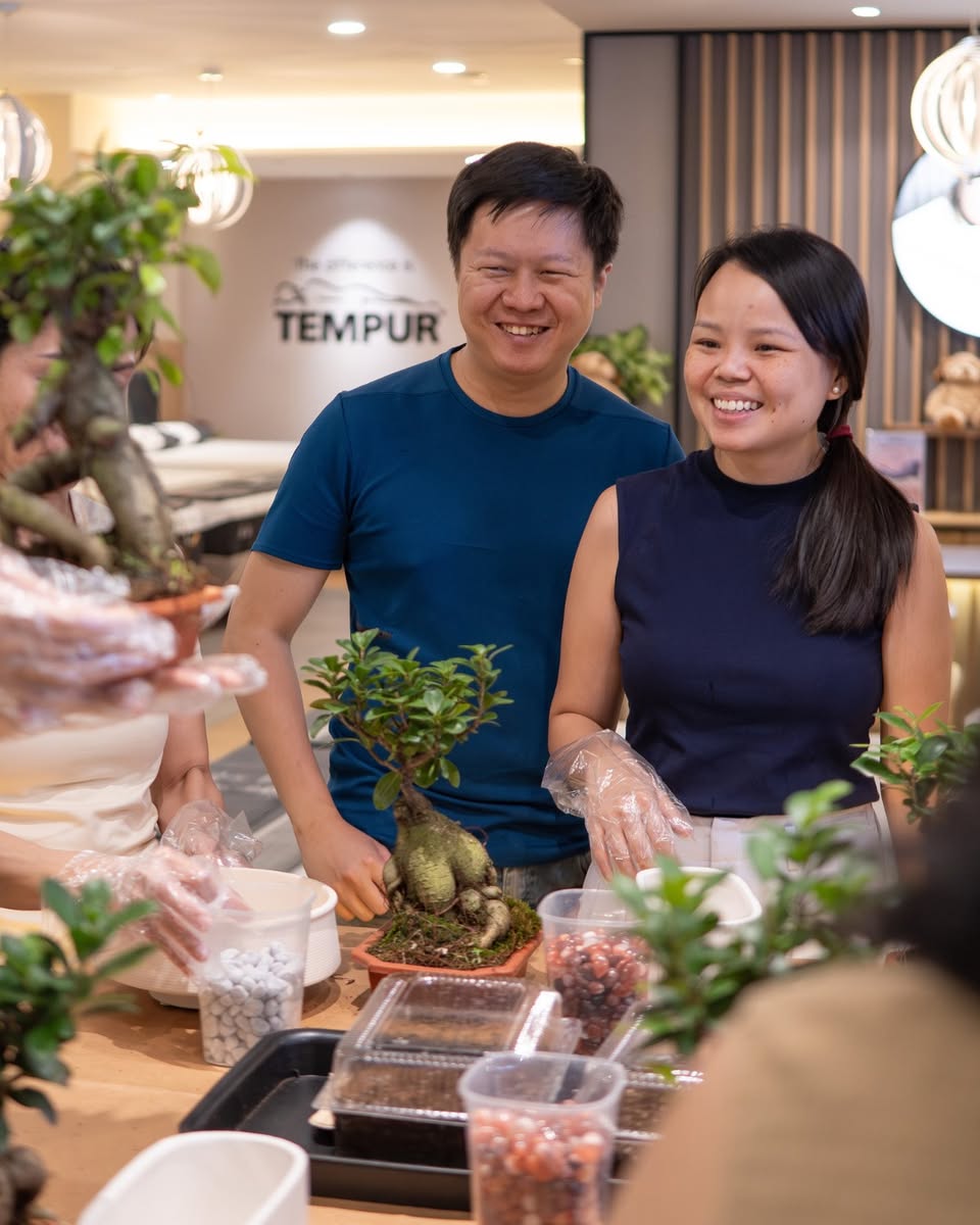 A stylish bedside table featuring a small, vibrant pocket plant.